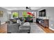 Comfortable living room featuring an oversized sectional sofa, modern décor, and natural light at 165 Montgomery Dr, Erie, CO 80516