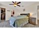Comfortable bedroom featuring a ceiling fan, natural light, and neutral decor with wood accents at 165 Montgomery Dr, Erie, CO 80516