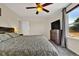 Comfortable main bedroom featuring a ceiling fan, natural light, and neutral decor with wood accents at 165 Montgomery Dr, Erie, CO 80516