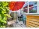 Cozy outdoor patio with a red umbrella, grill, and comfortable seating, ideal for relaxation at 165 Montgomery Dr, Erie, CO 80516