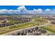 Expansive aerial view of a Primary-planned community featuring manicured green spaces, modern homes, and stunning mountain views at 5760 N Boston St, Denver, CO 80238