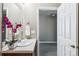 Bathroom features a single sink vanity with framed art and open doorway at 5760 N Boston St, Denver, CO 80238