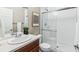 Bathroom featuring a single sink vanity, and a tiled shower with a glass door at 5760 N Boston St, Denver, CO 80238