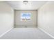 Empty bedroom features neutral walls, plush carpet and natural light at 5760 N Boston St, Denver, CO 80238