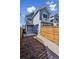 Two-story home with a charming patio, fenced yard, walkway, and lush landscaping creating a welcoming outdoor space at 5760 N Boston St, Denver, CO 80238