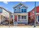 Charming two-story home featuring a red front door and inviting front porch at 5760 N Boston St, Denver, CO 80238