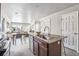 Open floor plan connecting kitchen with island to dining and living area at 5760 N Boston St, Denver, CO 80238