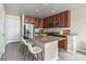 Open kitchen features stainless steel appliances, granite countertops, and eat-in island at 5760 N Boston St, Denver, CO 80238