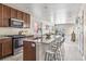 Kitchen features stainless steel appliances, granite countertops and modern cabinetry at 5760 N Boston St, Denver, CO 80238