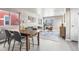 Open-concept living room with hardwood floors, modern furniture, and a dining area at 5760 N Boston St, Denver, CO 80238