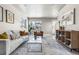 Well-lit living room featuring hardwood floors, comfortable seating, and natural light at 5760 N Boston St, Denver, CO 80238