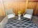 Charming patio space features cushioned wicker chairs, a modern accent table, and a patterned rug for cozy outdoor seating at 5760 N Boston St, Denver, CO 80238