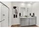 Modern bathroom features double sinks, granite countertops, a large mirror, and a glass-enclosed shower at 4723 Windmill Dr, Brighton, CO 80601