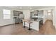 Modern kitchen with grey cabinets, stainless steel appliances, granite countertops and dark wood floors at 4723 Windmill Dr, Brighton, CO 80601