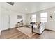 Spacious living area with wood-look floors, neutral décor, and plenty of natural light at 4723 Windmill Dr, Brighton, CO 80601