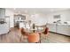 A modern living space with wood floors, open kitchen with grey cabinets, dining area, and a comfortable sitting area at 4723 Windmill Dr, Brighton, CO 80601