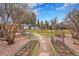 Landscaped backyard with garden beds and mature trees, offering a peaceful outdoor retreat at 6334 S Elati St, Littleton, CO 80120