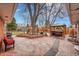 Entertainer's backyard featuring a brick patio, mature trees, hot tub gazebo, and a built-in outdoor kitchen area at 6334 S Elati St, Littleton, CO 80120