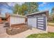Backyard featuring a modern shed with stylish doors and a well-maintained garden area, ideal for outdoor storage at 6334 S Elati St, Littleton, CO 80120