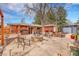 Expansive backyard oasis featuring a hot tub, fire pit area, lush landscaping, and outdoor seating at 6334 S Elati St, Littleton, CO 80120