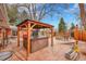 Outdoor living space boasting a gazebo with a hot tub, fire pit area, lush landscaping, and outdoor seating at 6334 S Elati St, Littleton, CO 80120