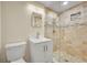 Modern bathroom with a glass shower, light fixtures, and white vanity at 6334 S Elati St, Littleton, CO 80120