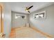Bright bedroom featuring hardwood floors, a modern ceiling fan, and dual windows for natural light at 6334 S Elati St, Littleton, CO 80120