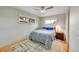 Cozy bedroom features a bed with blue pillows, a ceiling fan, and natural light at 6334 S Elati St, Littleton, CO 80120