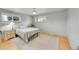 Light-filled bedroom with hardwood floors, two windows, a ceiling fan, and a cozy atmosphere at 6334 S Elati St, Littleton, CO 80120