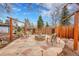 Inviting stone fire pit surrounded by comfortable seating, perfect for outdoor gatherings and relaxation at 6334 S Elati St, Littleton, CO 80120