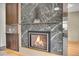 Elegant fireplace with marble surround and built-in shelving at 6334 S Elati St, Littleton, CO 80120