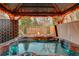 Covered hot tub with integrated lights, with view of fire pit and outdoor seating area at 6334 S Elati St, Littleton, CO 80120