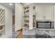 Well-organized spice rack cabinet adjacent to stainless steel microwave and stovetop at 6334 S Elati St, Littleton, CO 80120