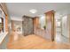 View of living and dining areas, showcasing hardwood floors and a marble fireplace at 6334 S Elati St, Littleton, CO 80120