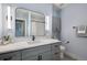 Modern bathroom with a sleek vanity, framed mirror, and contemporary lighting fixtures at 7745 S Trenton Ct, Centennial, CO 80112