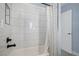 Bathroom featuring a white tiled shower and a patterned shower curtain at 7745 S Trenton Ct, Centennial, CO 80112