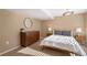 Bedroom with natural lighting, a large dresser, and minimalist decor at 7745 S Trenton Ct, Centennial, CO 80112