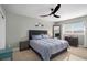 Cozy bedroom featuring a large bed, modern ceiling fan, and a bright window at 7745 S Trenton Ct, Centennial, CO 80112