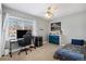 Comfortable bedroom features a large window, ceiling fan, and unique sports decor accents at 7745 S Trenton Ct, Centennial, CO 80112