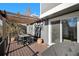 Outdoor deck area perfect for dining and relaxing, with a wooden pergola at 7745 S Trenton Ct, Centennial, CO 80112