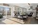 Dining area with hardwood floors, a fireplace, stylish lighting, and sliding door to patio at 7745 S Trenton Ct, Centennial, CO 80112