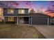 Charming two-story home featuring an attached two-car garage and well-maintained front yard at 7745 S Trenton Ct, Centennial, CO 80112