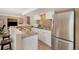 Cozy kitchen with stainless steel appliances, a breakfast bar, and white cabinetry at 7745 S Trenton Ct, Centennial, CO 80112