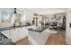 Open concept kitchen with an island and stainless steel appliances, seamlessly flowing into the dining and living area at 7745 S Trenton Ct, Centennial, CO 80112