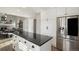 Beautiful kitchen featuring a central island with sleek countertops, stainless steel appliances, and ample storage at 7745 S Trenton Ct, Centennial, CO 80112
