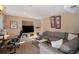 Cozy living room featuring a comfortable sectional sofa, built-in shelving, and recessed lighting at 7745 S Trenton Ct, Centennial, CO 80112