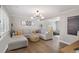 Inviting living room with hardwood floors, recessed lighting, and a comfortable sectional sofa at 7745 S Trenton Ct, Centennial, CO 80112