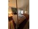 Bedroom with a four-poster bed, wooden dresser, and bright natural light at 1901 Clear Creek Dr # A-104, Georgetown, CO 80444