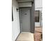The gray front door features the number 104 and is located on a sidewalk at 1901 Clear Creek Dr # A-104, Georgetown, CO 80444