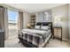 Well-lit bedroom featuring a comfortable bed, modern decor, and a bright window at 18379 Field Mint Pt, Parker, CO 80134